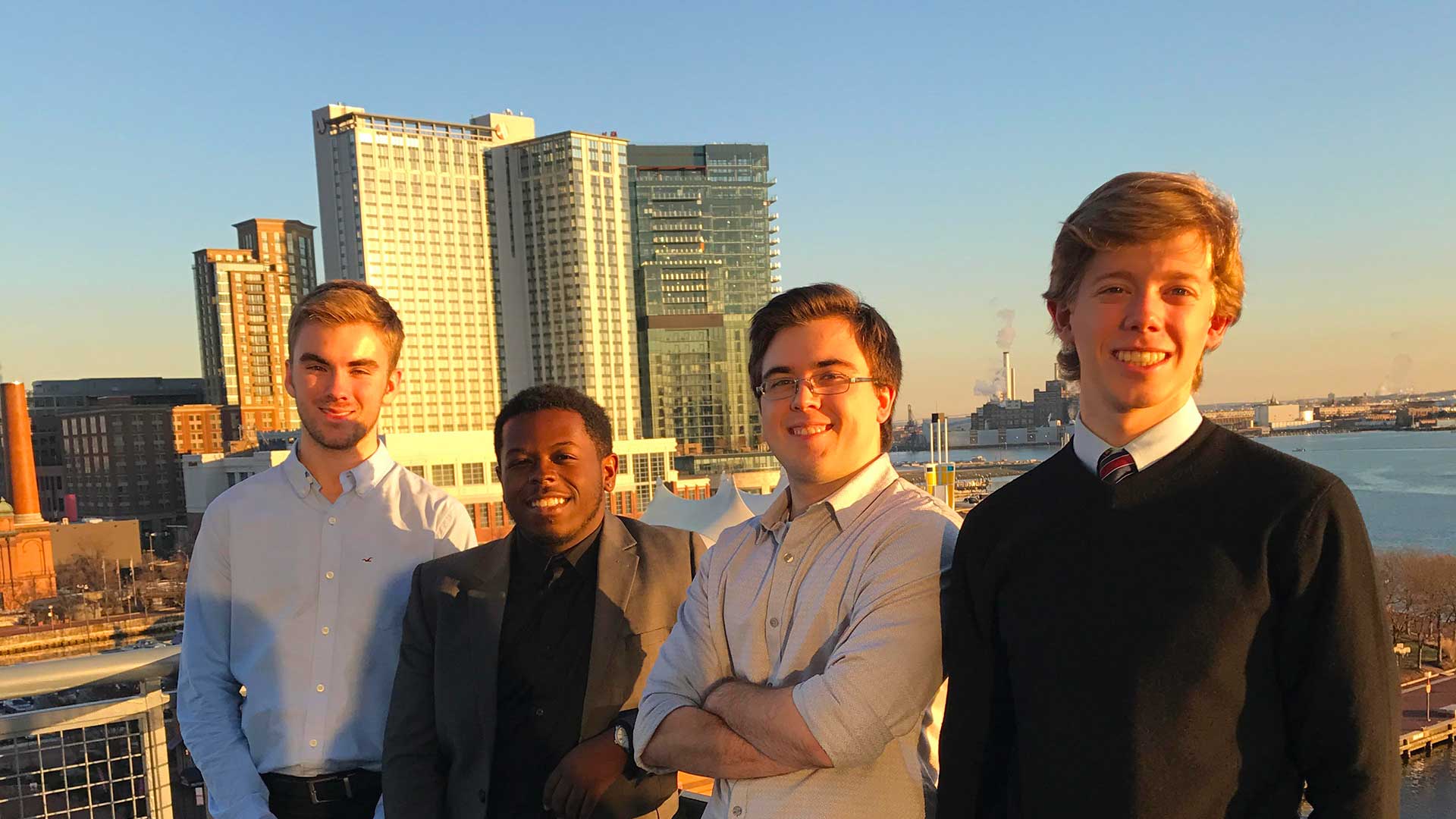 SMCM interns on a rooftop with a city backdrop.