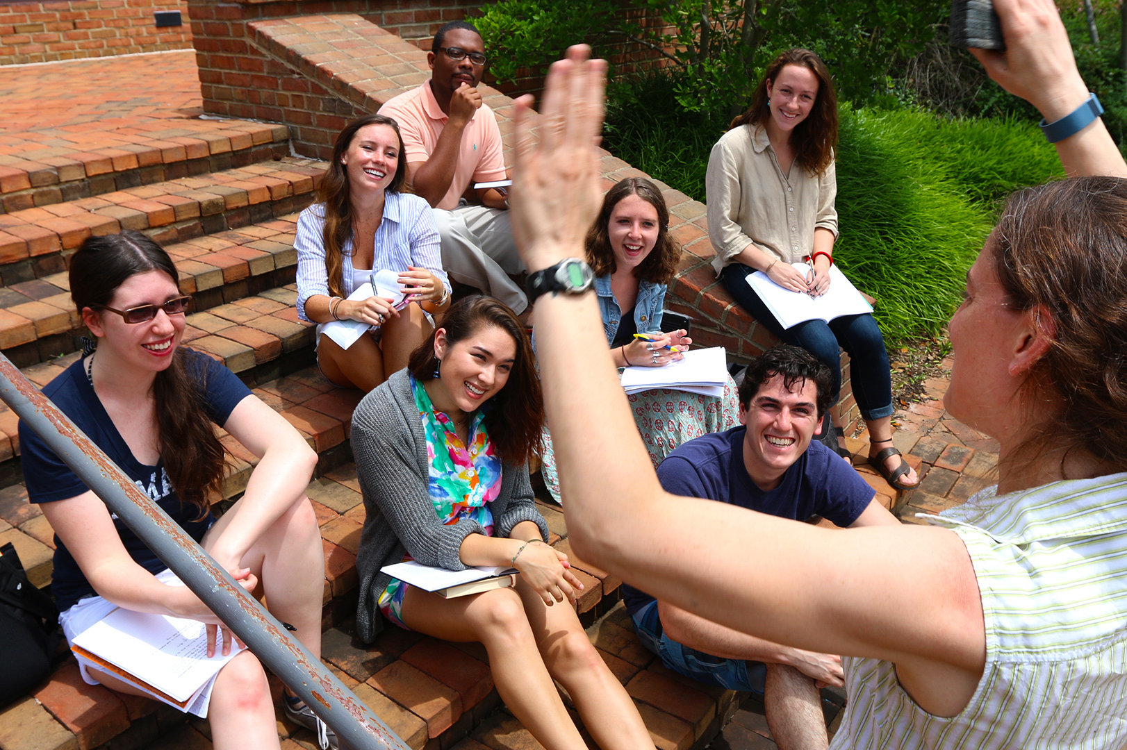 SMCM students enjoy an outdoor class on the brick steps near the science department.