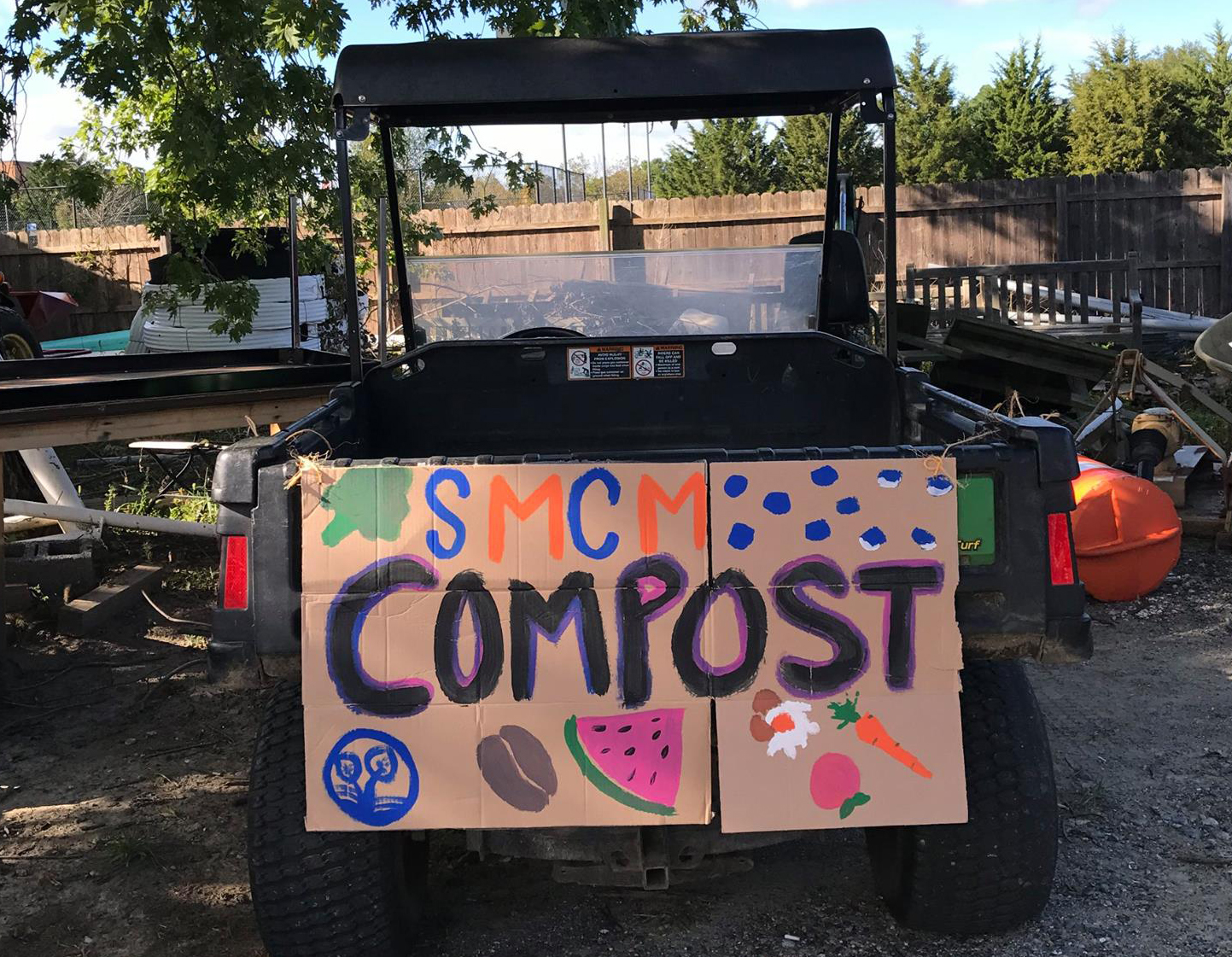 image of a smcm cart with a compost poster behind it