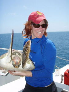 Dr. Qamar Schuyler with a sea turtle