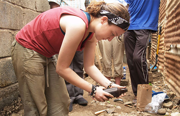 Student looking at a bottle in The Gambia