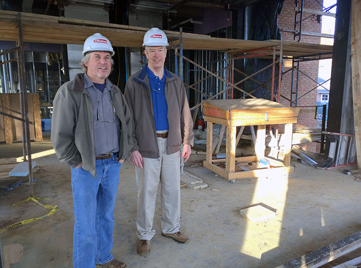 Robert Brown and Donald Wince in hard hats standing on the construction site of Anne Arundel Hall