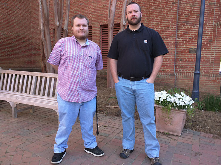 Photo of Will Looney and Josh Wilcox standing in front of the Library.