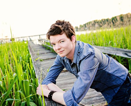 Griffyn Gilligan poses on a bridge over a marsh.
