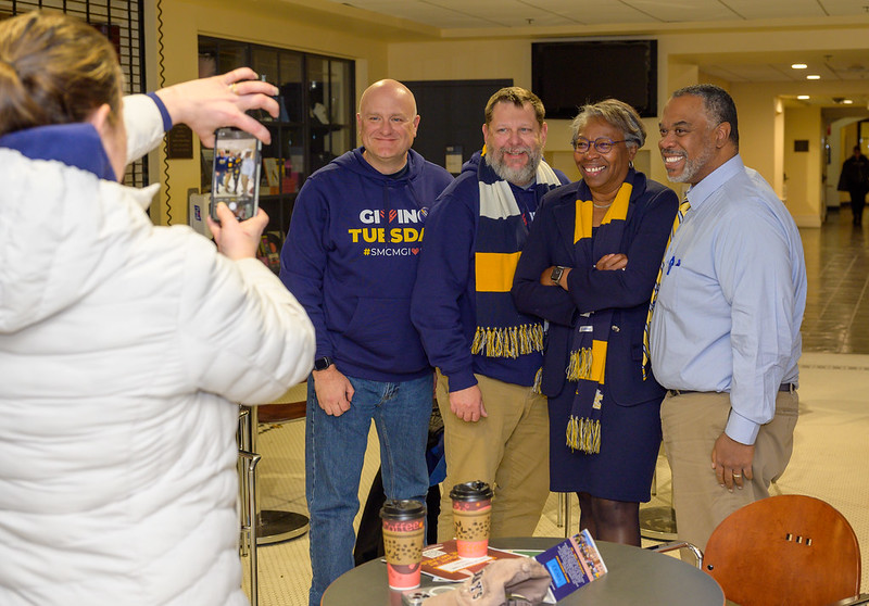 President Jordan stops for a photo with alumni during the 2024 Giving Tuesday campaign