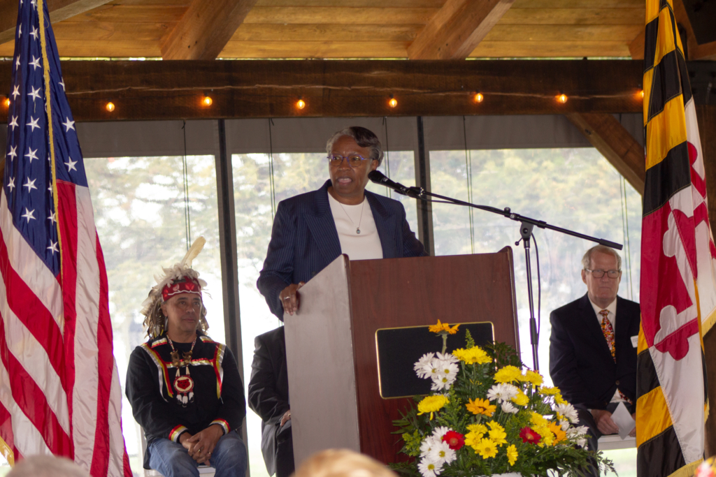 President Jordan pictured at a podium giving the keynote address at Historic St. Mary's City's Maryland Day ceremony under the new Margaret Brent Pavilion at HSMC.