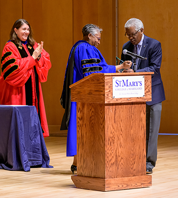 President Jordan hands an award to Board of Trustee Lawrence Leak '76 Leek during the 2023 Awards Convocation held on April 14.