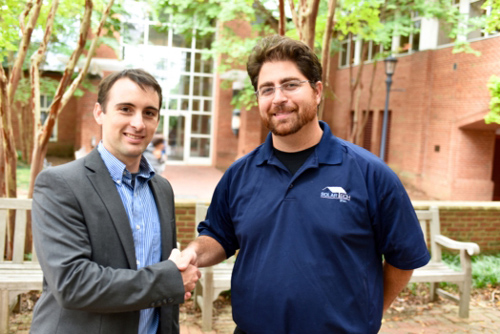 Dr Troy Townsend and Solar Tech project manager Jeff Croisetiere shake hands