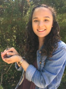 SMCM student Elizabeth Johnson holds a white-throated sparrow