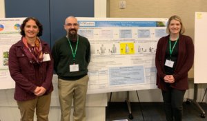 Doctors Mertz, Bowers, and Neiles stand in front of their CUR poster