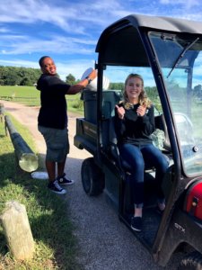 Two students, Isaac Page and Afton Hauer, are hard at work collecting compost in the compost cruiser!