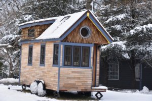 SMCM tiny house covered in snow