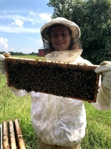 Student holding a bee hive insert